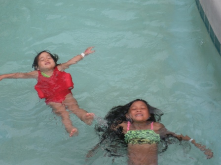 Kasen and Karis floating in the pool